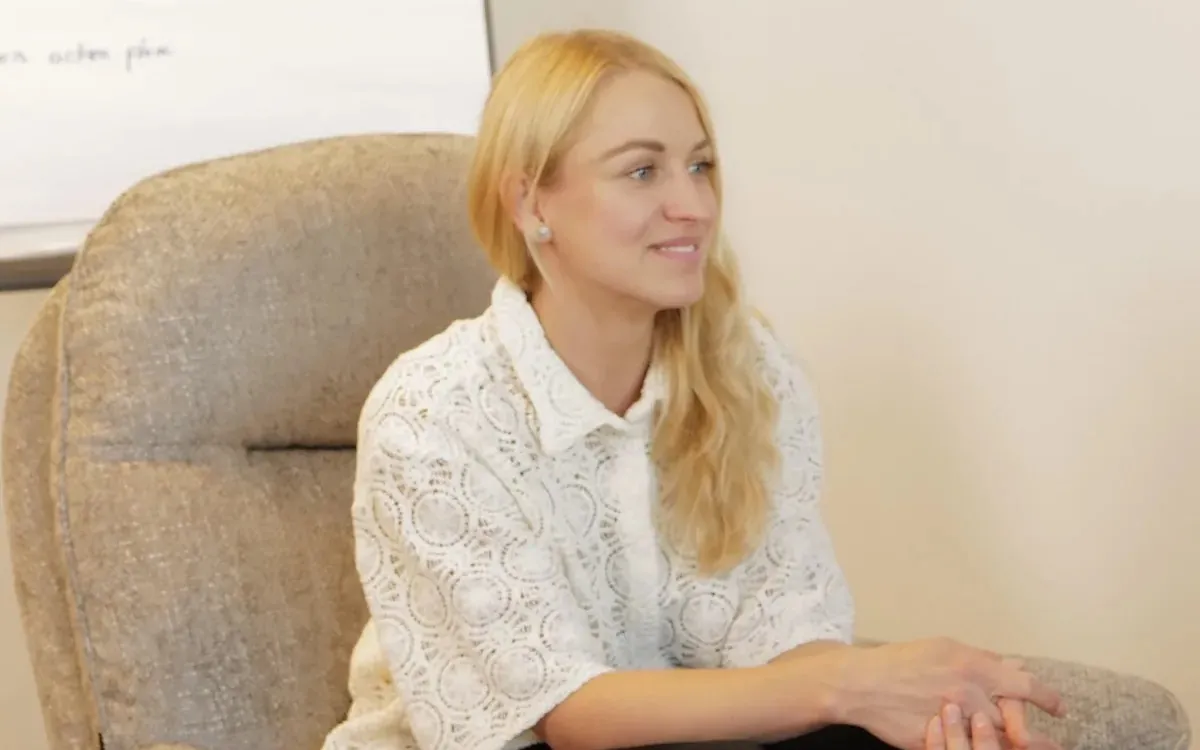 Adela Roos seated in an armchair in her Delft office